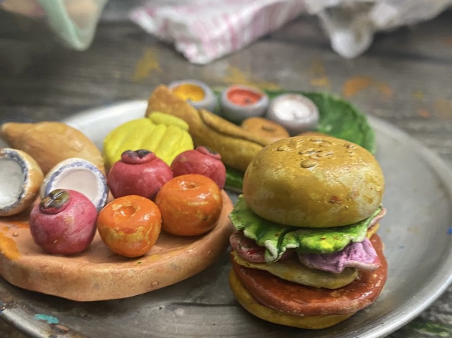 Miniature Clay Burger - Deliciously detailed in clay. Every layer from bun to patty crafted with precision and artistic flair.